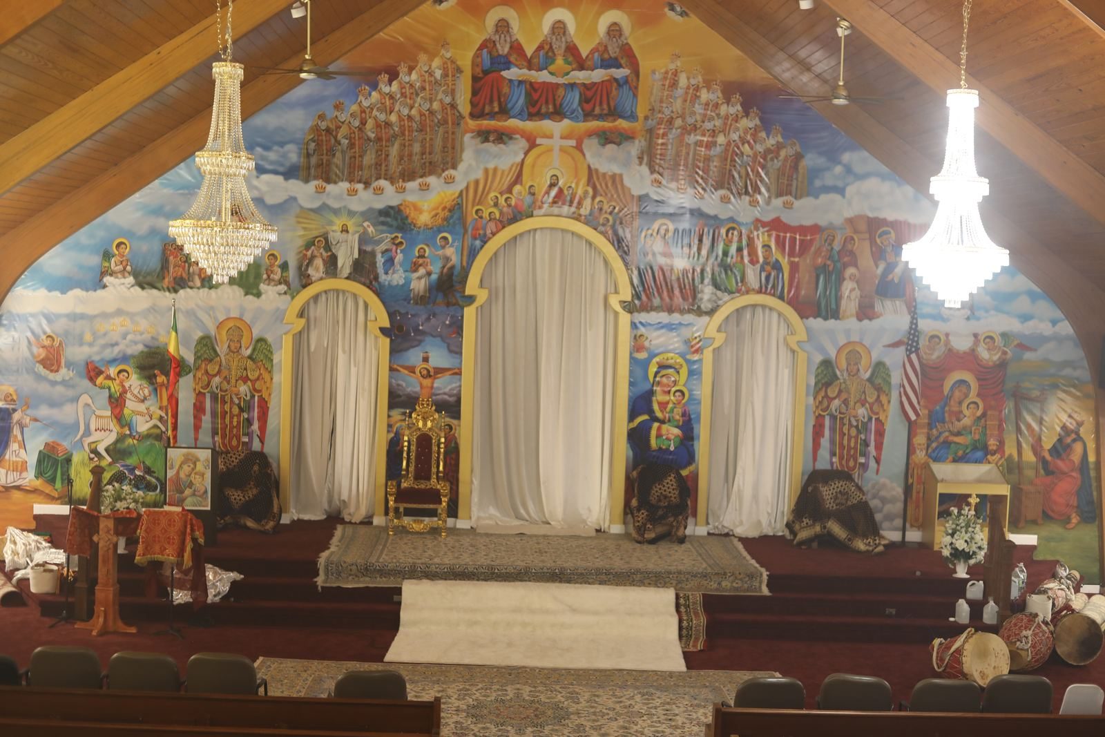 The sanctuary with its painted icon wall, golden arches and the curtained Holy of Holies